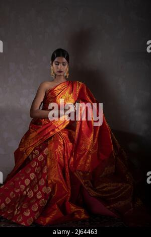 Female with orange silk dress in deep meditating breathing calmly in the  sunset Stock Photo - Alamy