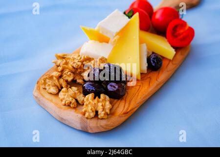 Two glasses of wine and cheese plate. Aperetif. Stock Photo