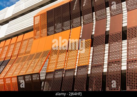 The orange and brown modern corrugated metal exterior of a new parking garage in Lowell, Massachusetts. Stock Photo