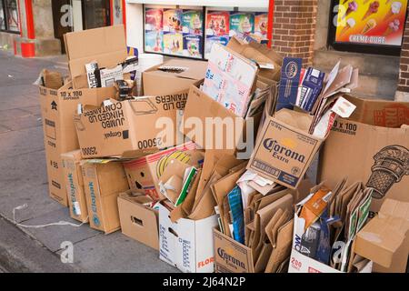 Cardboard boxes on city sidewalk ready to be picked up for recycling, Old Montreal, Quebec, Canada. Stock Photo