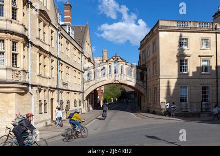 Cyclists about to go under the Bridge of Sighs; a skyway connecting two parts of Hertford College in Oxford Stock Photo