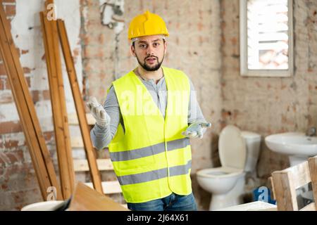 Young foreman discussing building renovation plan with customer Stock Photo