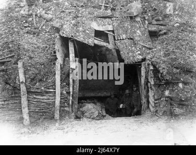 British soldiers stand in the entrance to a captured German dug-out near Puisieux, captured during operations on the Ancre in February 1917. Stock Photo