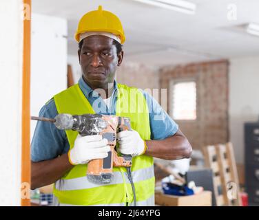 Portrait of man builder using electric hammer Stock Photo