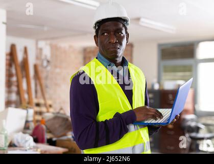 Portrait of man builder with laptop Stock Photo