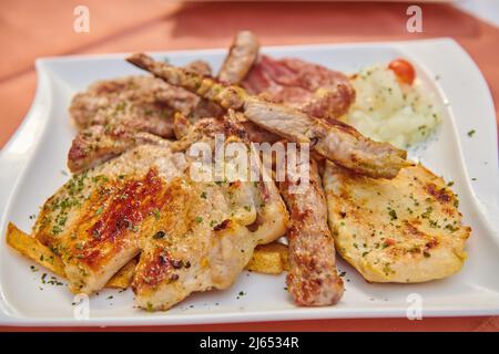 assorted different types of meat on a plate Stock Photo