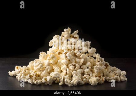 pile of popcorn on black background, delicious, low-fat, healthy snack, closeup Stock Photo