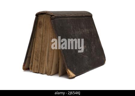 Close up of very old worn partially damaged book with leather cover placed in the shape of a triangle roof or tent on white background as a concept fo Stock Photo