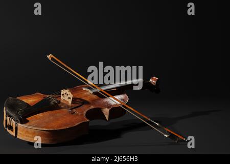 Rustic violin on black background. Musical instrument template. Vintage violin with copy space. Stock Photo