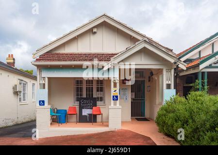 A small house converted to a local General Practice surgery in Five Dock, Sydney, with a chalkboard sign at the front offering Covid-19 booster shots Stock Photo