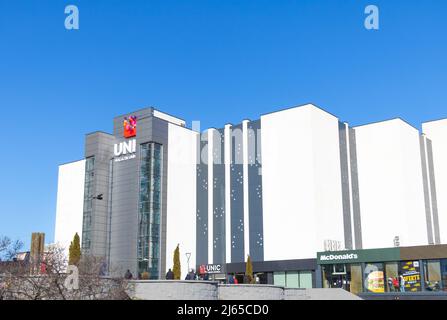 Chisinau, Moldova - February 16, 2022 A shopping mall called Unic on the blue sky background. Stock Photo