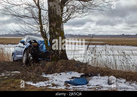 January 25, 2022, Riga, Latvia: car collision with tree at the scene of an accident on a road Stock Photo