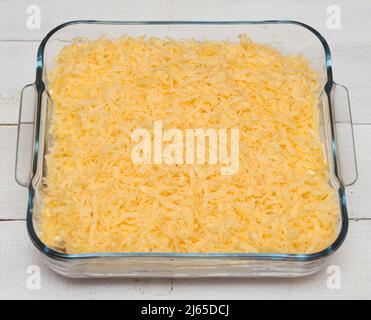 Top view of uncooked lasagna in transparent tray on a wooden table Stock Photo