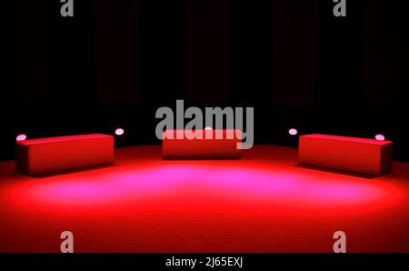Three seats and red lighting on stage Stock Photo