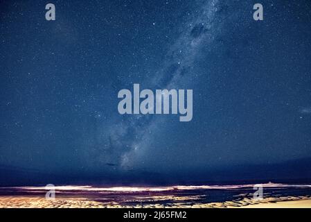 Night sky with Milky Way over the sea, Middle Beach, Kenton on Sea, South Africa, 05 April 2022. Stock Photo