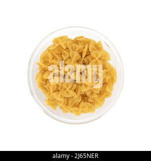pasta farfalle in glass bowl isolated on white background, raw pasta in shape of bow, top view Stock Photo