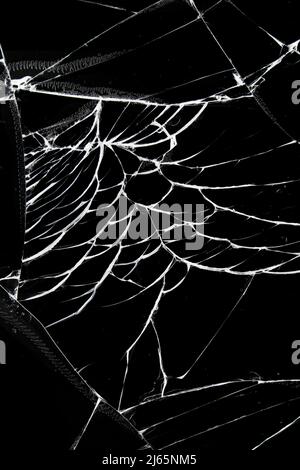 Broken protective glass of smartphone with cracks in hand on black  background Stock Photo - Alamy