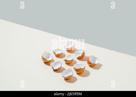 Nine Empty Egg Shells on a White Background with a Grey Wall Stock Photo