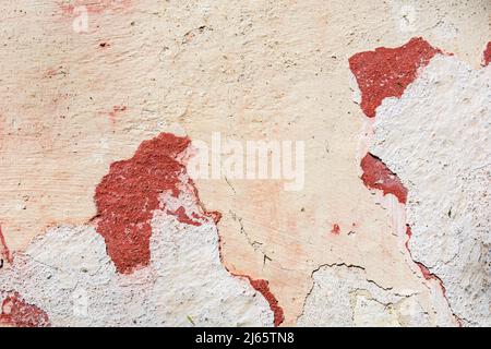 Old and weathered grunge wall with red pattern outdoor on an old house. Close up and copy space for text or design Stock Photo