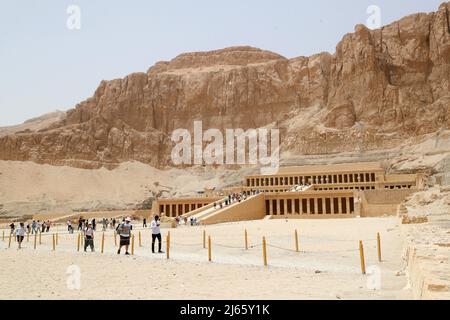 Cairo, Egypt. 26th Apr, 2022. Tourists visit the Temple of Hatshepsut in Luxor, Egypt, April 26, 2022. Luxor, a capital of ancient Upper Egypt known as Thebes, is now a tourist destination famous for the historic temple buildings and other relics. Credit: Sui Xiankai/Xinhua/Alamy Live News Stock Photo
