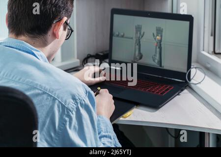 digital artist working on 3d graphics using a graphics tablet. Stock Photo
