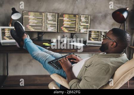 Profile side view portrait of attractive focused skilled guy expert technician editing code at workplace workstation indoors Stock Photo
