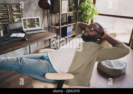 Photo of exhausted guy developer sit chair nap sleep after hardware web java script testing in workspace Stock Photo