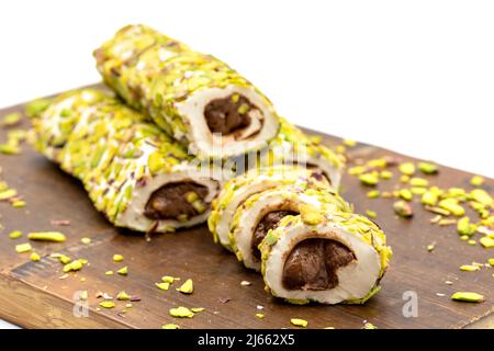 Turkish Delight with Pistachio. Turkish delight with chocolate filling, isolated on a white background. Traditional Turkish cuisine delicacies. close Stock Photo