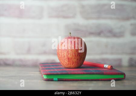 black to school concept with apple on notepad on table. Stock Photo