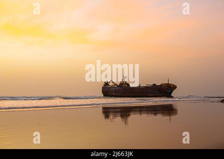 Old boat stuck in the sand of a beach Stock Photo