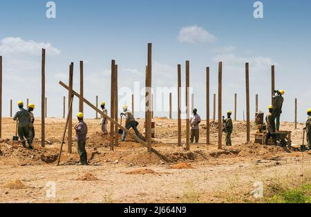 Ghana - Wooden poles are used on a Accra construction site. Stock Photo