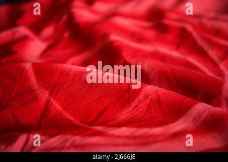 Wrinkled red fabric. Bright colorful background for design. Stock Photo