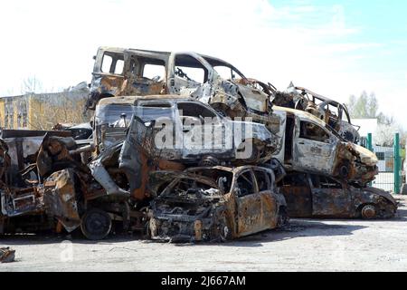 Non Exclusive: HOSTOMEL, UKRAINE - APRIL 27, 2022 - Cars destroyed by Russian troops are piled on the premises of Antonov Airport, an international ca Stock Photo