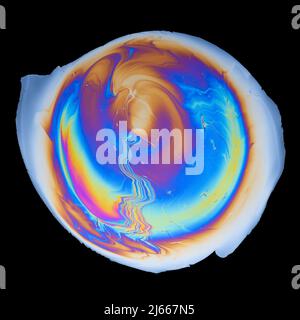 Vivid interference colors from an oil film on water isolated on black background Stock Photo