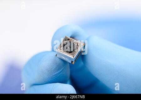 Smartphone single camera module in scientist hands Stock Photo