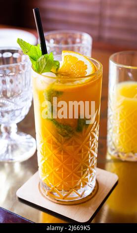 non alcoholic sea buckthorn cocktail with mint and orange in a glass glass Stock Photo