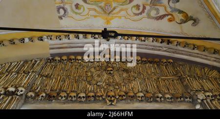 Chapel of Bones, Skulls and Bones embedded in the wall above the entrance, Evora, Alentejo, Portugal Stock Photo