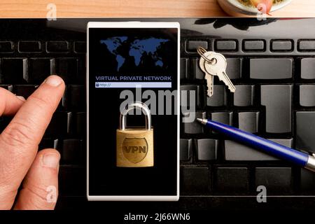 VPN (virtual private network) concept, man using a vpn software on a smartphone Stock Photo