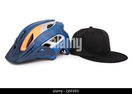 Bike helmet and a baseball snapback hat side by side, isolated on white background. Fashion and head accessories concept. Stock Photo