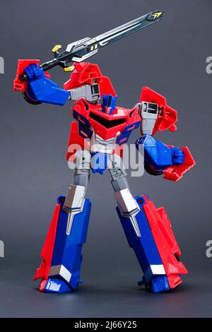 Robot transformer red and blue on black background. Toys for children, toy store. Stock Photo