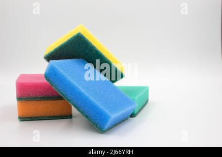 Multi-colored sponges for household work from foam rubber, stack, on a white background. Stock Photo