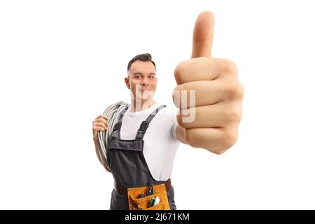 Electrician carrying cables on his shoulder and showing thumbs up isolated on white background Stock Photo