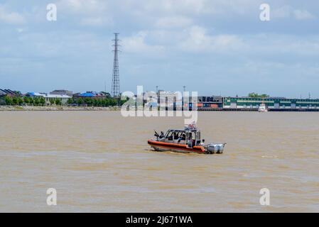 NEW ORLEANS, LA, USA - APRIL 23, 2022: U.S. Coast Guard boats guard the river along Woldenberg Park during the French Quarter Festival Stock Photo