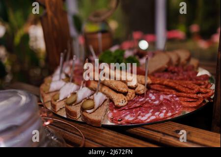 Slicing different varieties of meat. Wedding buffet Stock Photo