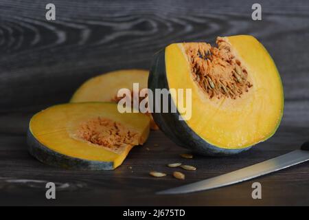 Sliced pumpkin. A pumpkin is a cultivar of winter squash that is round with smooth, slightly ribbed skin, and is most often deep yellow to orange in c Stock Photo