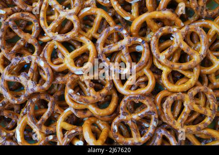 Mini pretzels snacks with salt as a background Stock Photo