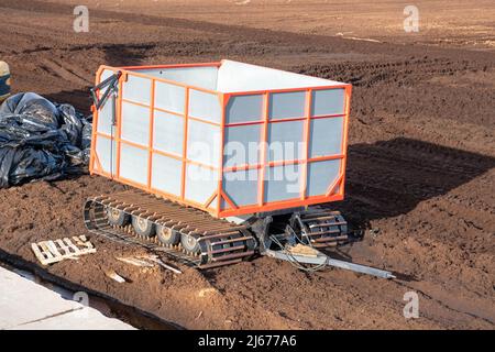 a tractor trailer in a swamp for the collection and removal of peat. Stock Photo