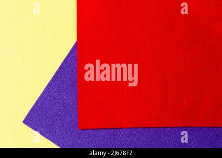 Abstract colorful geometric felt texture background. Bright yellow, blue, red colors felt textile for craft. Top view, flat lay Stock Photo