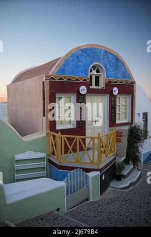 Oia, Greece - May 11, 2021 : View of a beautiful and colorful traditional coffee shop with a small terrace in Oia  Greece Stock Photo