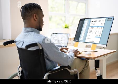 African Accountant With Disability Working On Computer In Wheelchair Stock Photo